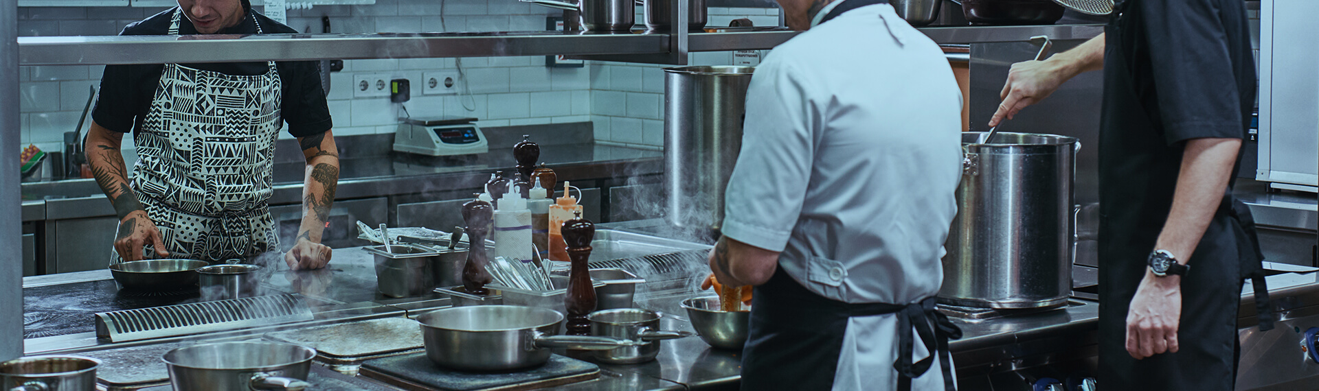 Image of people in a kitchen using an grease trap